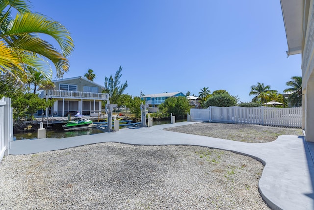 view of yard with a dock and a water view