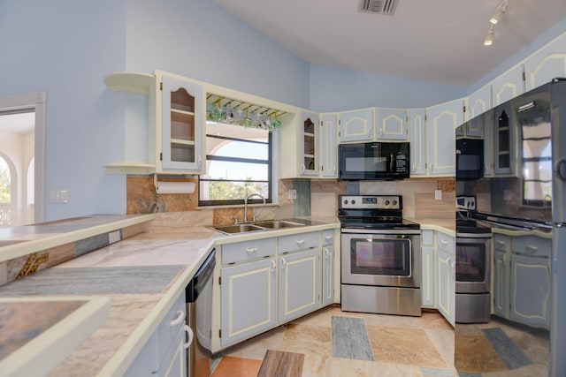 kitchen with white cabinets, lofted ceiling, sink, and black appliances