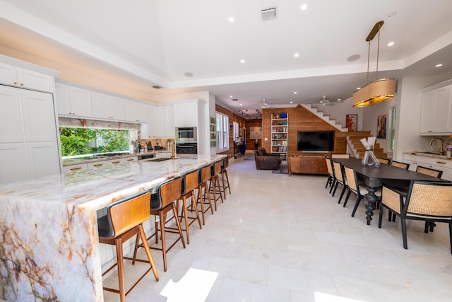 316 Southard St, Key West, FL 33040 - kitchen with decorative backsplash, a tray ceiling, light stone countertops, and recessed lighting
