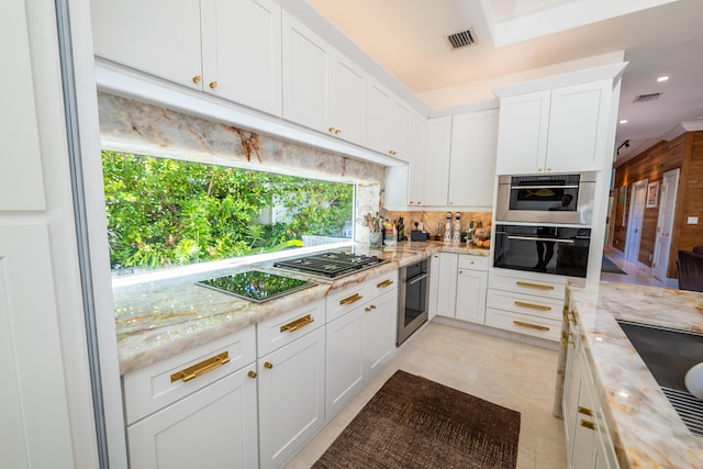 316 Southard St, Key West, FL 33040 - kitchen with stainless steel appliances, backsplash, white cabinets, light stone countertops, and recessed lighting