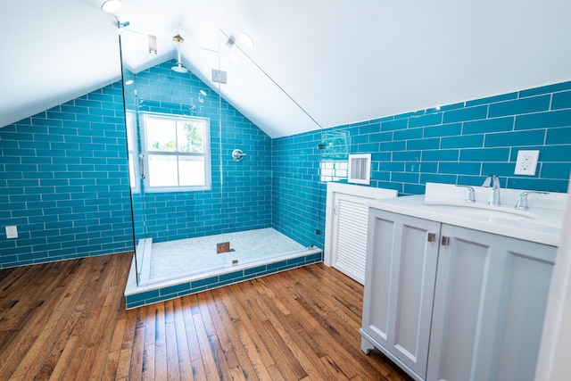 316 Southard St, Key West, FL 33040 - bathroom with tile walls, a stall shower, hardwood / wood-style flooring, lofted ceiling, and vanity