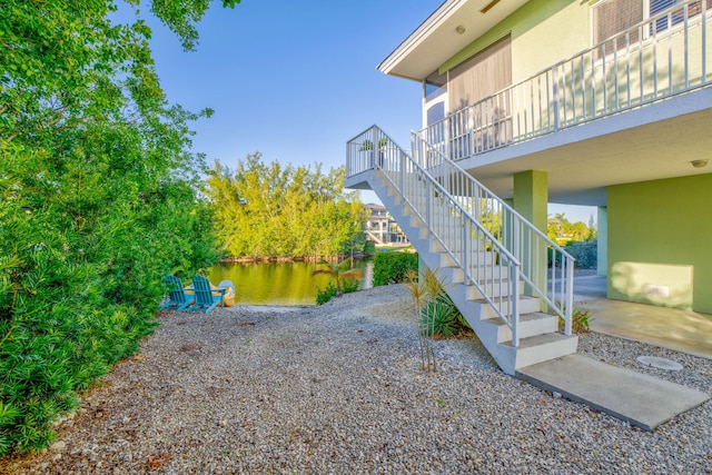 exterior space featuring a water view and a patio