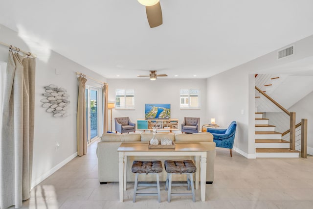 living room with a healthy amount of sunlight, light tile patterned floors, and ceiling fan