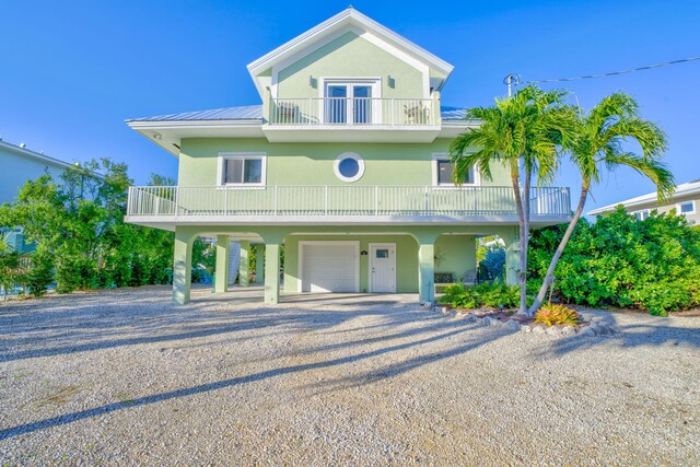 beach home with a balcony and a garage