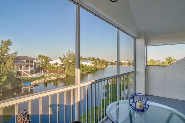 unfurnished sunroom featuring a water view