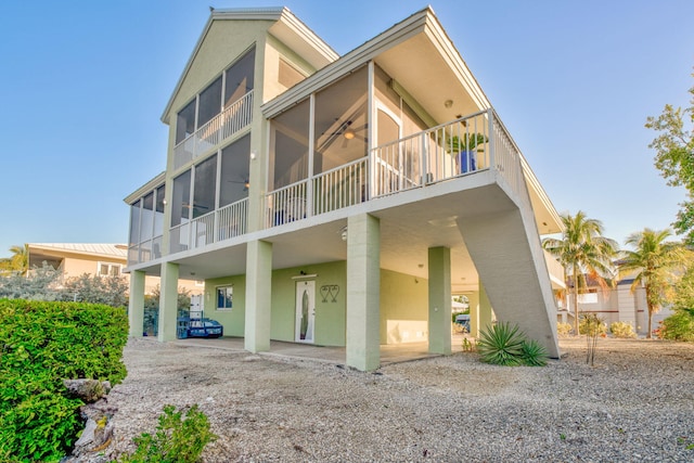 rear view of house featuring a patio and ceiling fan