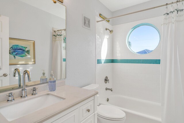 full bathroom featuring shower / tub combo, vanity, and toilet