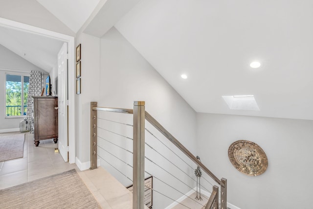 corridor featuring vaulted ceiling with skylight