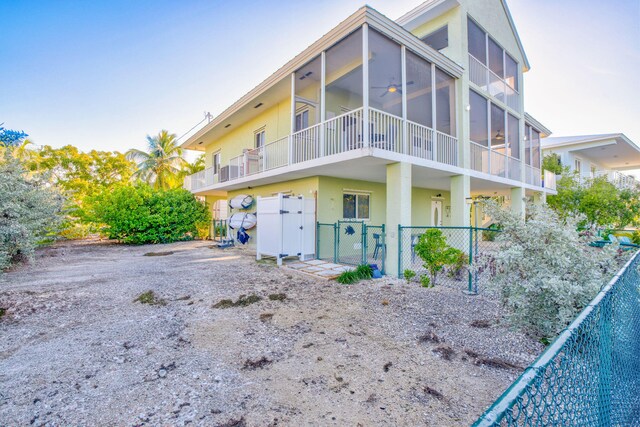 rear view of property with a sunroom