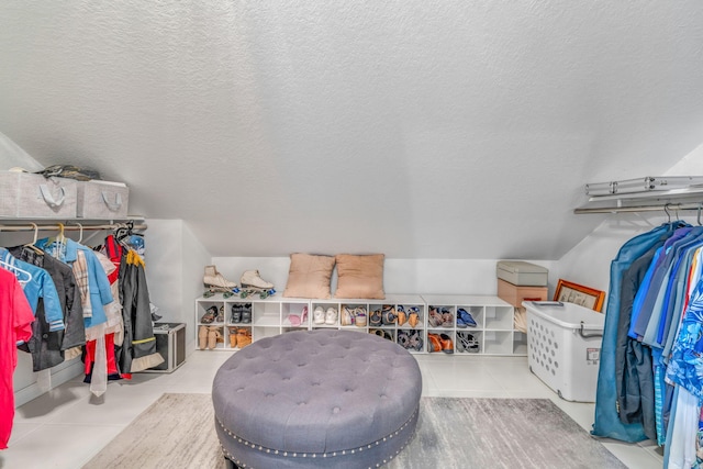 walk in closet featuring vaulted ceiling and tile patterned floors