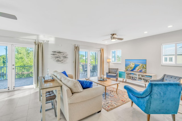 living room featuring ceiling fan and a wealth of natural light