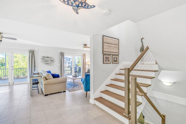 stairs featuring ceiling fan and french doors