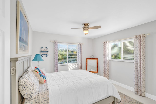 bedroom featuring ceiling fan and multiple windows