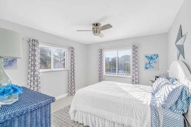 bedroom with ceiling fan and multiple windows