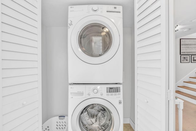 washroom featuring stacked washing maching and dryer