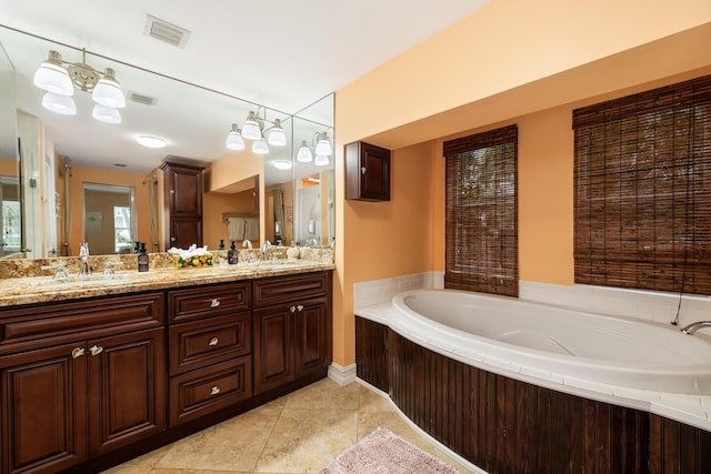 bathroom featuring vanity, a bathtub, and tile patterned floors