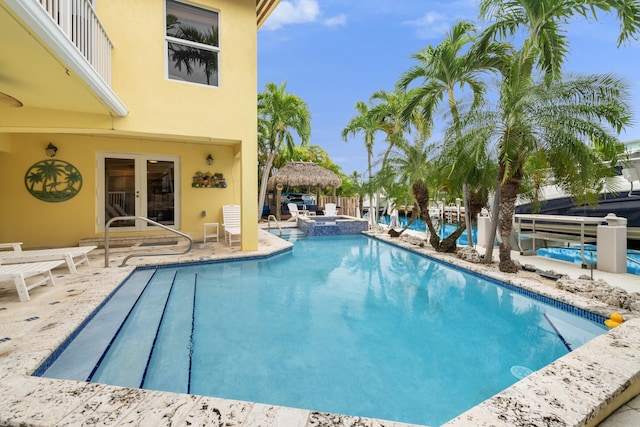 view of pool with a patio and an in ground hot tub