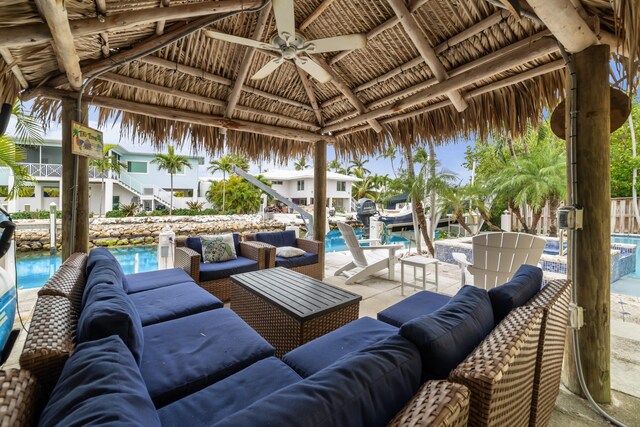 view of patio with an outdoor living space, a gazebo, and ceiling fan