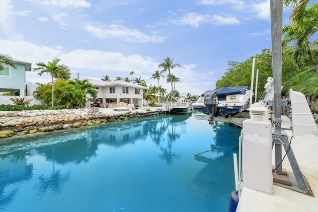 view of pool featuring a water view, grilling area, and a boat dock