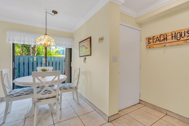 dining room featuring light tile patterned floors and crown molding