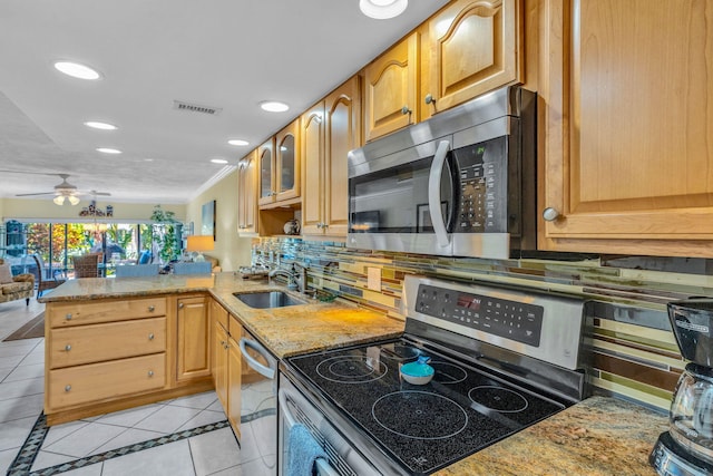 kitchen featuring appliances with stainless steel finishes, kitchen peninsula, sink, and light tile patterned floors