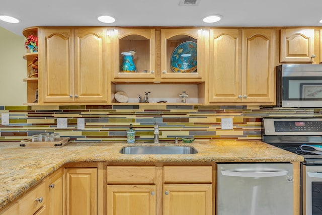 kitchen with tasteful backsplash, sink, stainless steel appliances, light stone countertops, and light brown cabinets