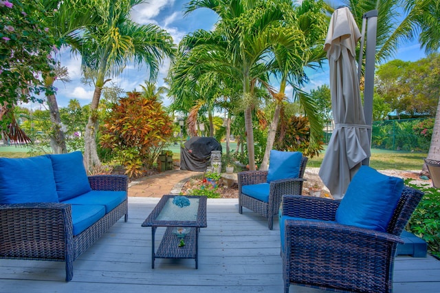 wooden deck featuring a grill and outdoor lounge area