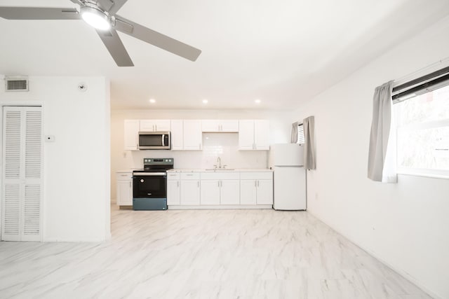 kitchen featuring sink, ceiling fan, white cabinets, and appliances with stainless steel finishes