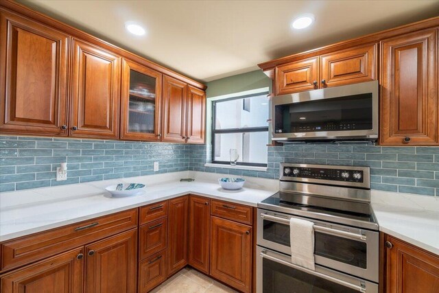 1998 Overseas Hwy Unit A31, Marathon, FL 33050 - kitchen with light countertops, brown cabinets, and appliances with stainless steel finishes