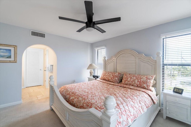 1998 Overseas Hwy Unit A31, Marathon, FL 33050 - bedroom with light colored carpet, a ceiling fan, baseboards, visible vents, and arched walkways