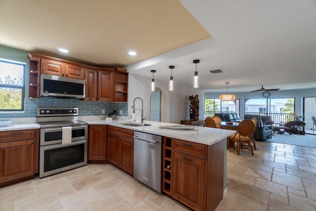 1998 Overseas Hwy Unit A31, Marathon, FL 33050 - kitchen featuring open shelves, stainless steel appliances, a sink, a peninsula, and stone tile flooring