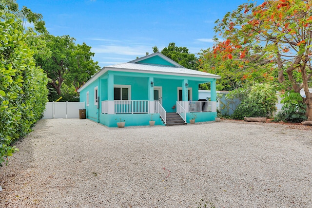 811 La Paloma Rd, Key Largo, FL 33037 - shotgun-style home featuring a porch and stucco siding