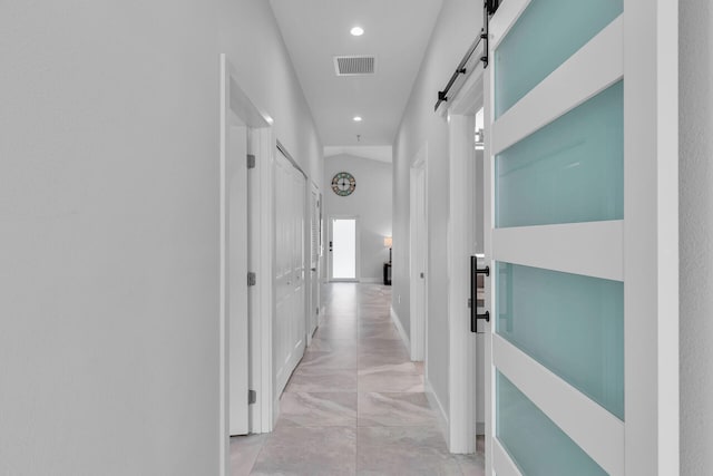 811 La Paloma Rd, Key Largo, FL 33037 - hall featuring light marble finish floors, recessed lighting, a barn door, and baseboards