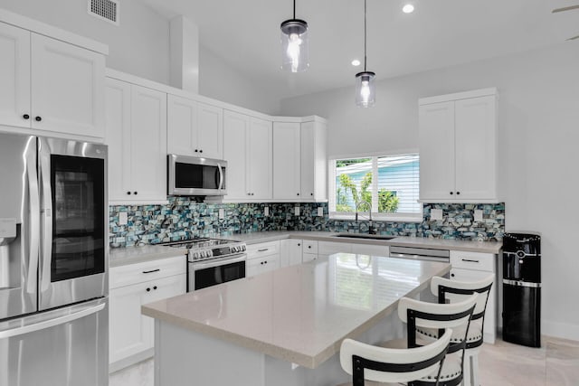 811 La Paloma Rd, Key Largo, FL 33037 - kitchen featuring appliances with stainless steel finishes, a sink, decorative backsplash, a center island, and recessed lighting