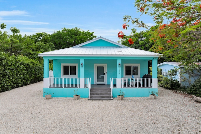 811 La Paloma Rd, Key Largo, FL 33037 - view of front of home with a porch, metal roof, stucco siding, and a standing seam roof