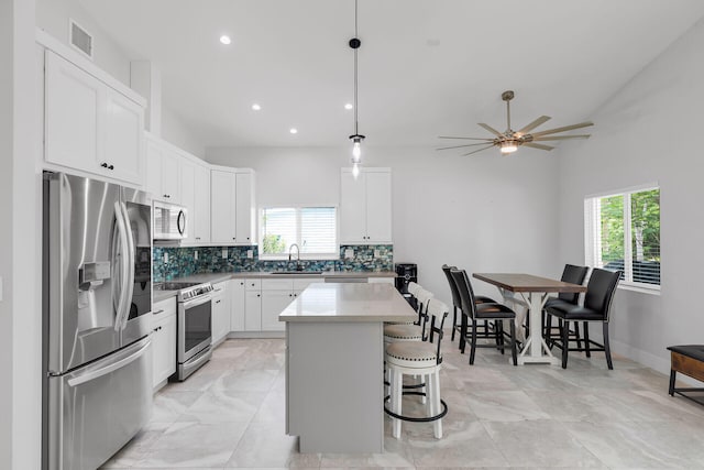 811 La Paloma Rd, Key Largo, FL 33037 - kitchen featuring stainless steel appliances, plenty of natural light, tasteful backsplash, a breakfast bar area, and recessed lighting
