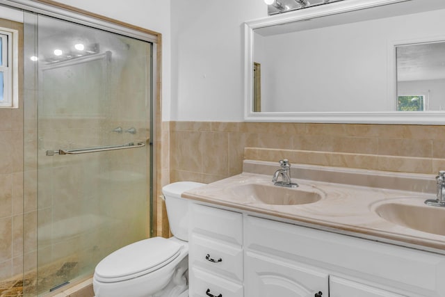 bathroom with vanity, tile walls, walk in shower, and toilet