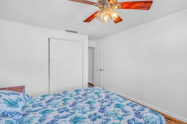 bedroom with hardwood / wood-style floors, a closet, and ceiling fan