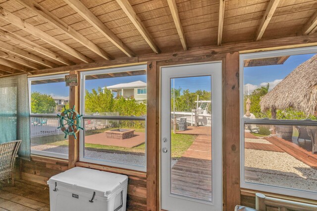 entryway featuring wood ceiling, a healthy amount of sunlight, and beam ceiling