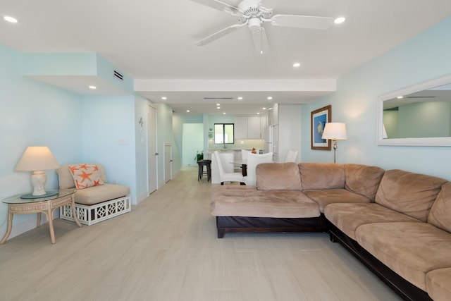 living room with ceiling fan and light hardwood / wood-style floors