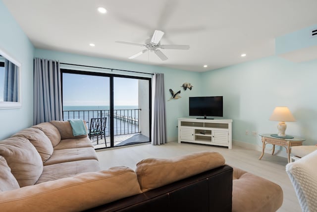 living room with ceiling fan and light wood-type flooring