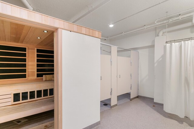 basement with built in features and a textured ceiling