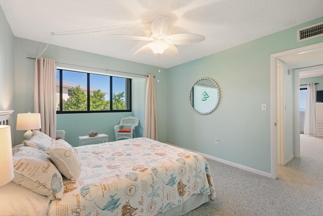 bedroom featuring ceiling fan, carpet, and a textured ceiling