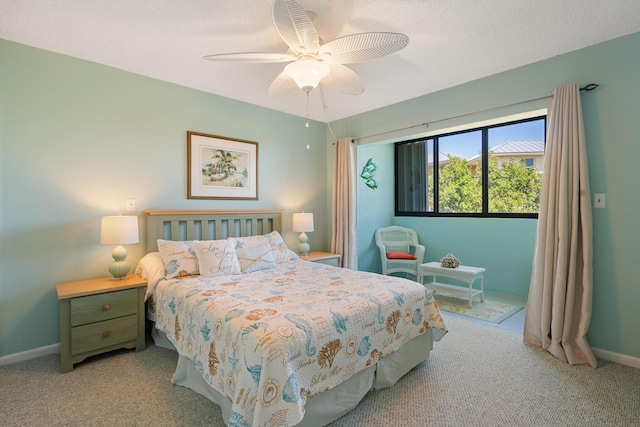 bedroom with light carpet, ceiling fan, and a textured ceiling