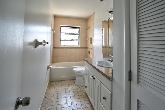 full bathroom with vanity, tiled shower / bath, and toilet