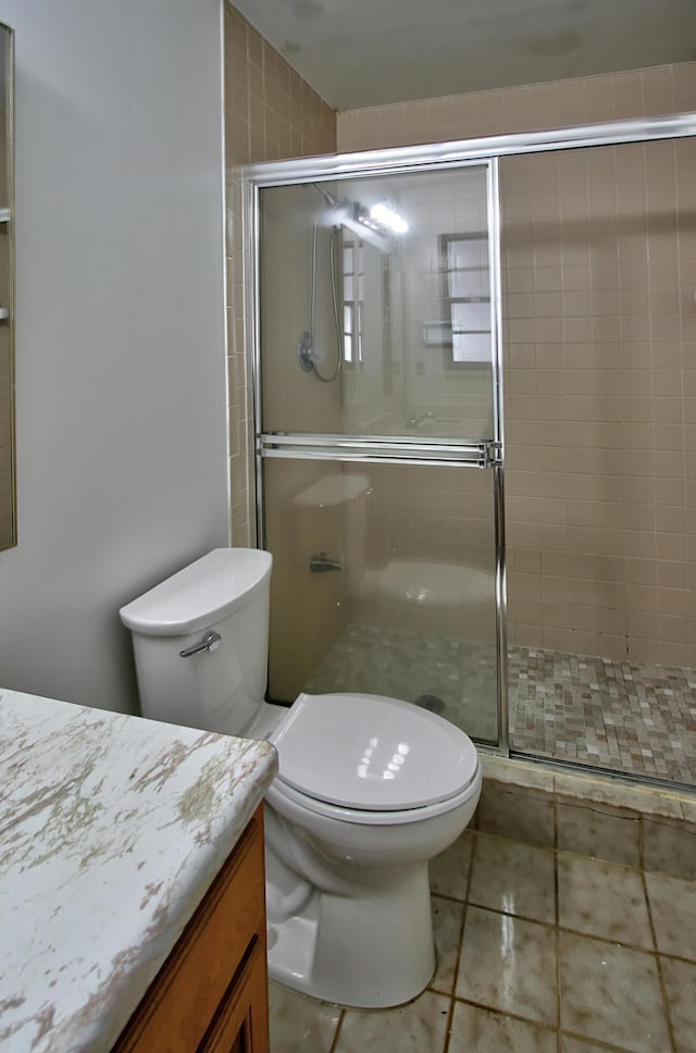 bathroom with vanity, an enclosed shower, tile patterned floors, and toilet