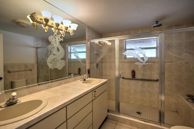 bathroom featuring vanity, an enclosed shower, tile patterned floors, and toilet