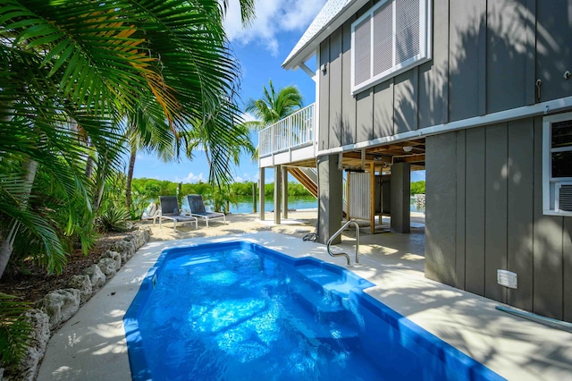 view of pool featuring a patio area and a water view