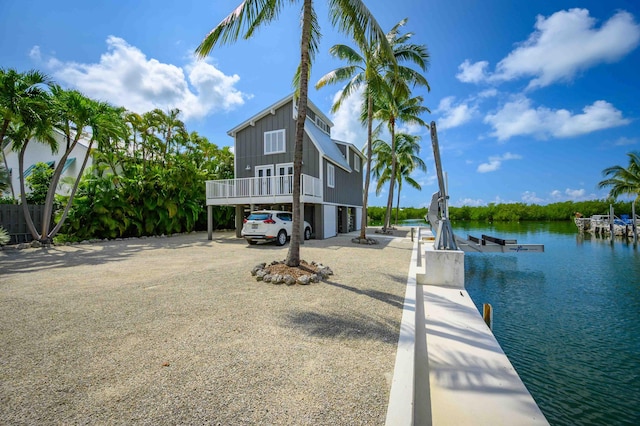 exterior space featuring a dock and a water view