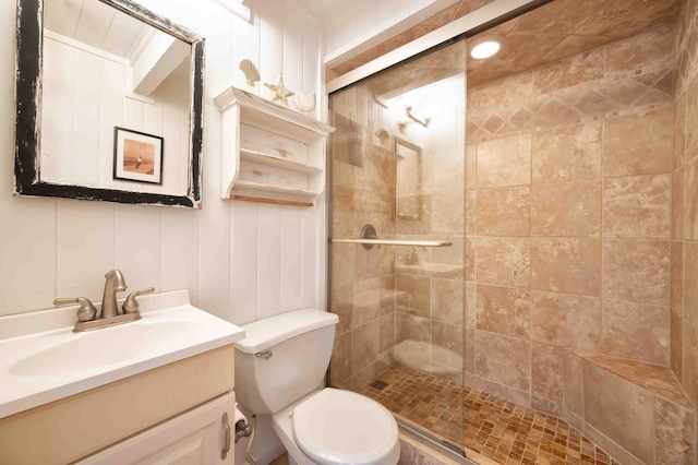 bathroom featuring an enclosed shower, vanity, and toilet